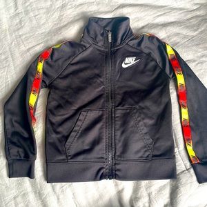 Nike Black track suit jacket with red orange yellow gradient detail